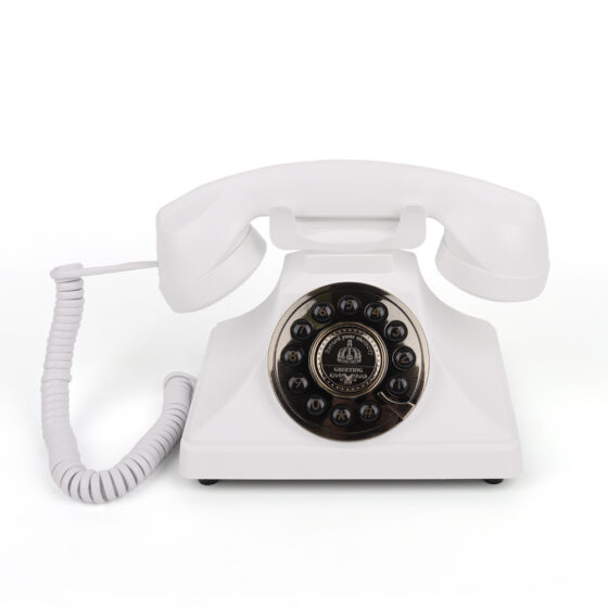 White push button telephone with black rotary dial, handset on base