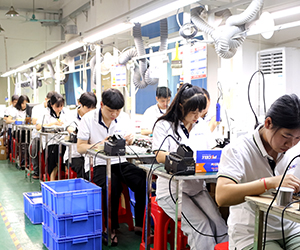 About Company – CHEETA factory assembly line, workers assembling telephones in clean environment.